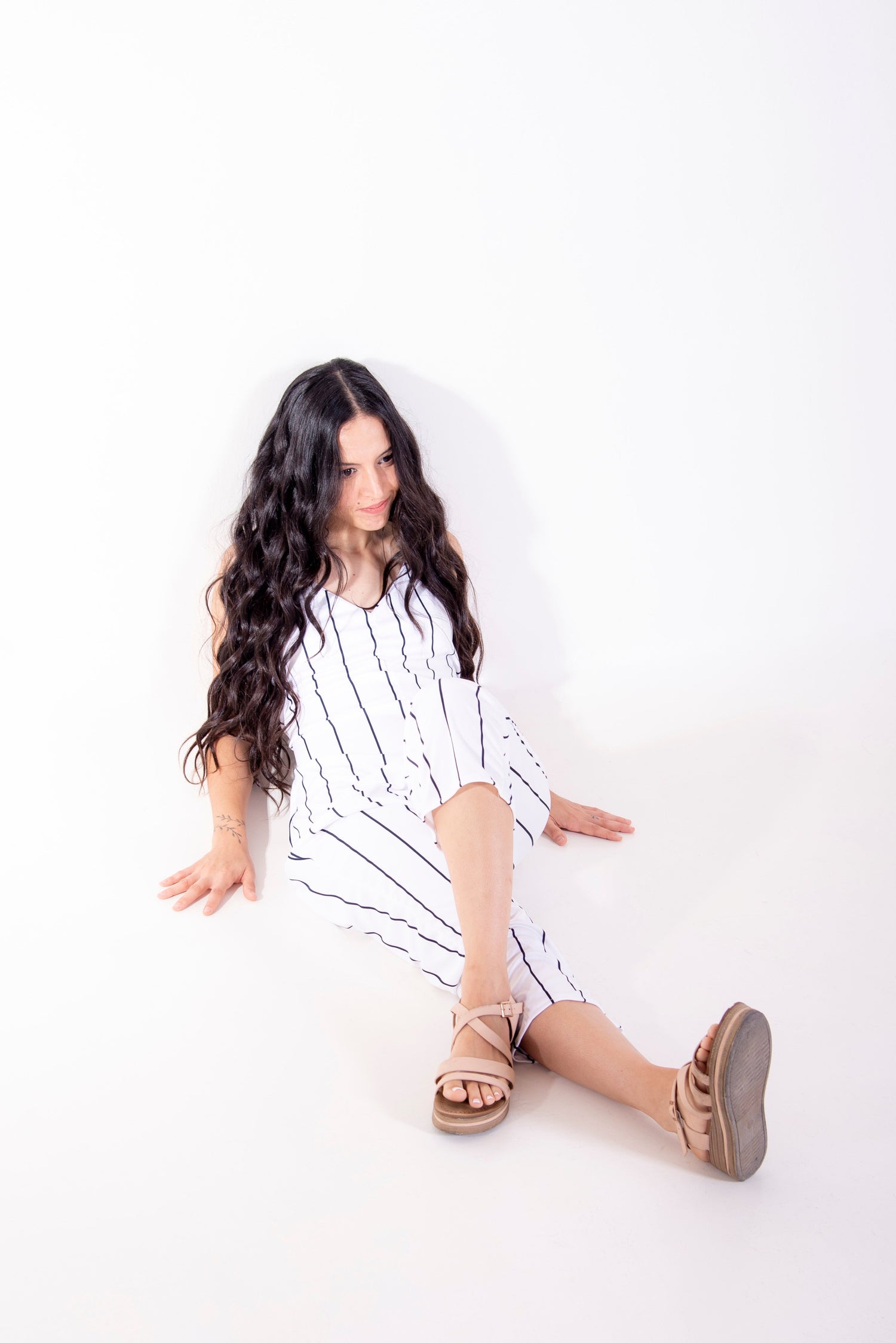 Woman wearing white striped wrap jumpsuit from jumpsuit sewing patterns collection by The Bobbin Bloom