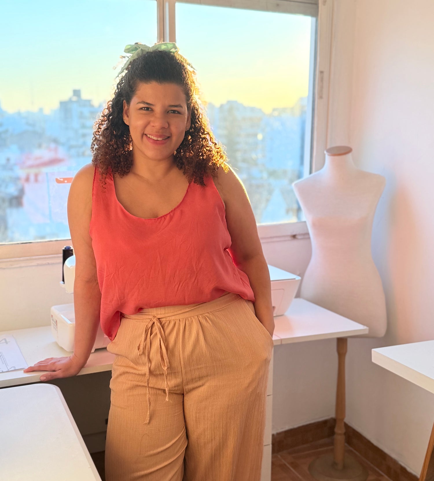 Pattern designer wearing coral Blossom Tank in sewing studio - adapting vision into digital sewing patterns at The Bobbin Bloom