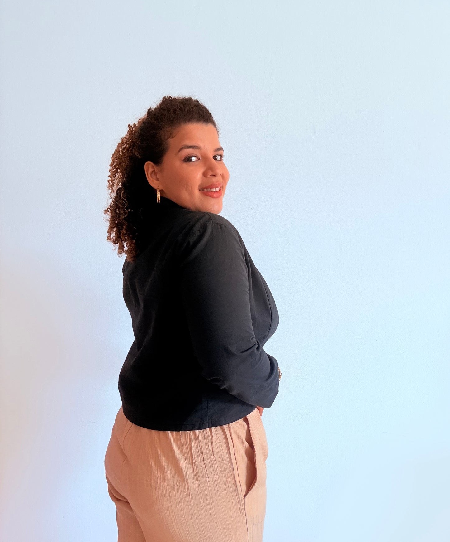 Woman wearing a black camellia unlined jacket 