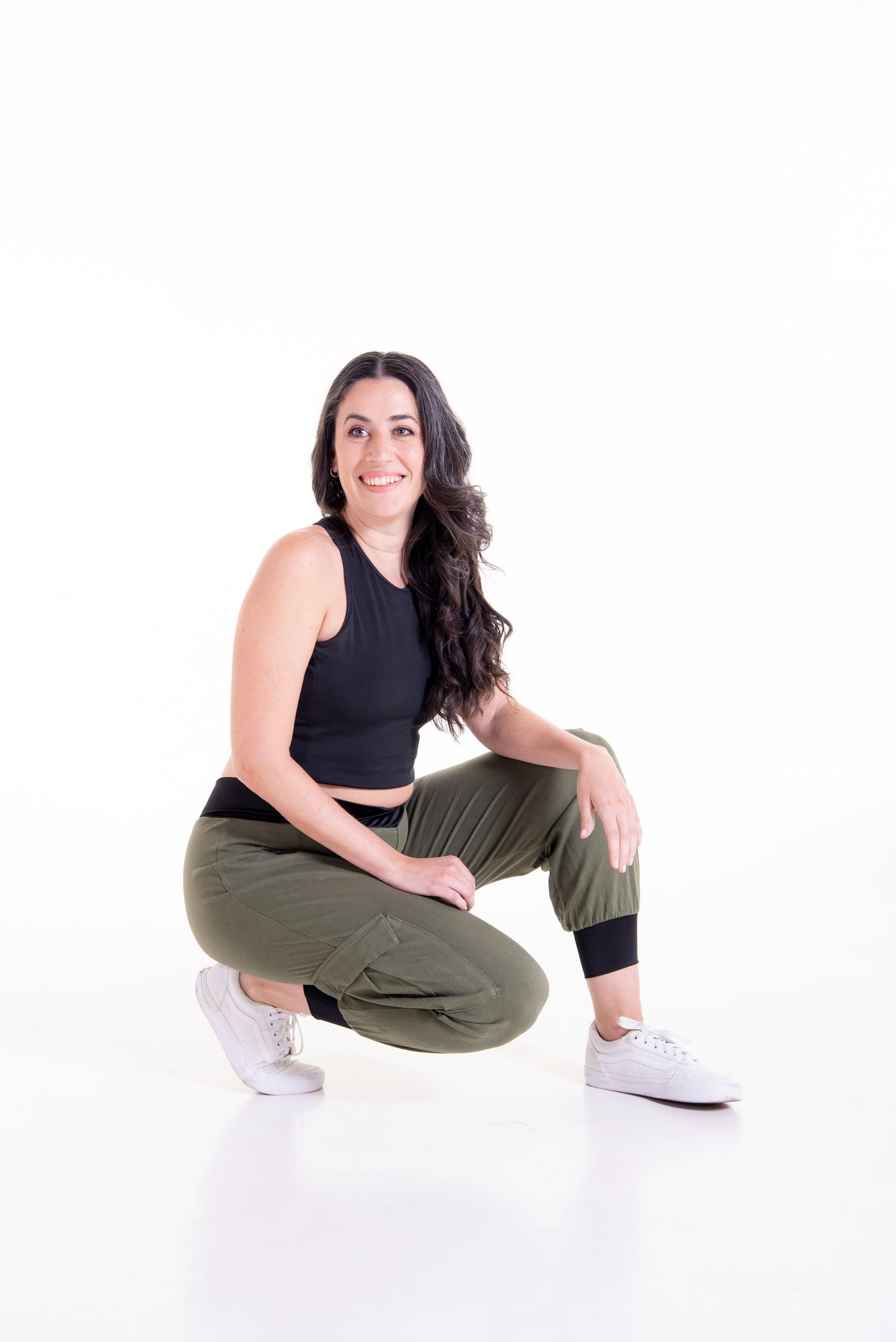 Olive green Flax cargo pants styled seated pose - comfortable fit showcase