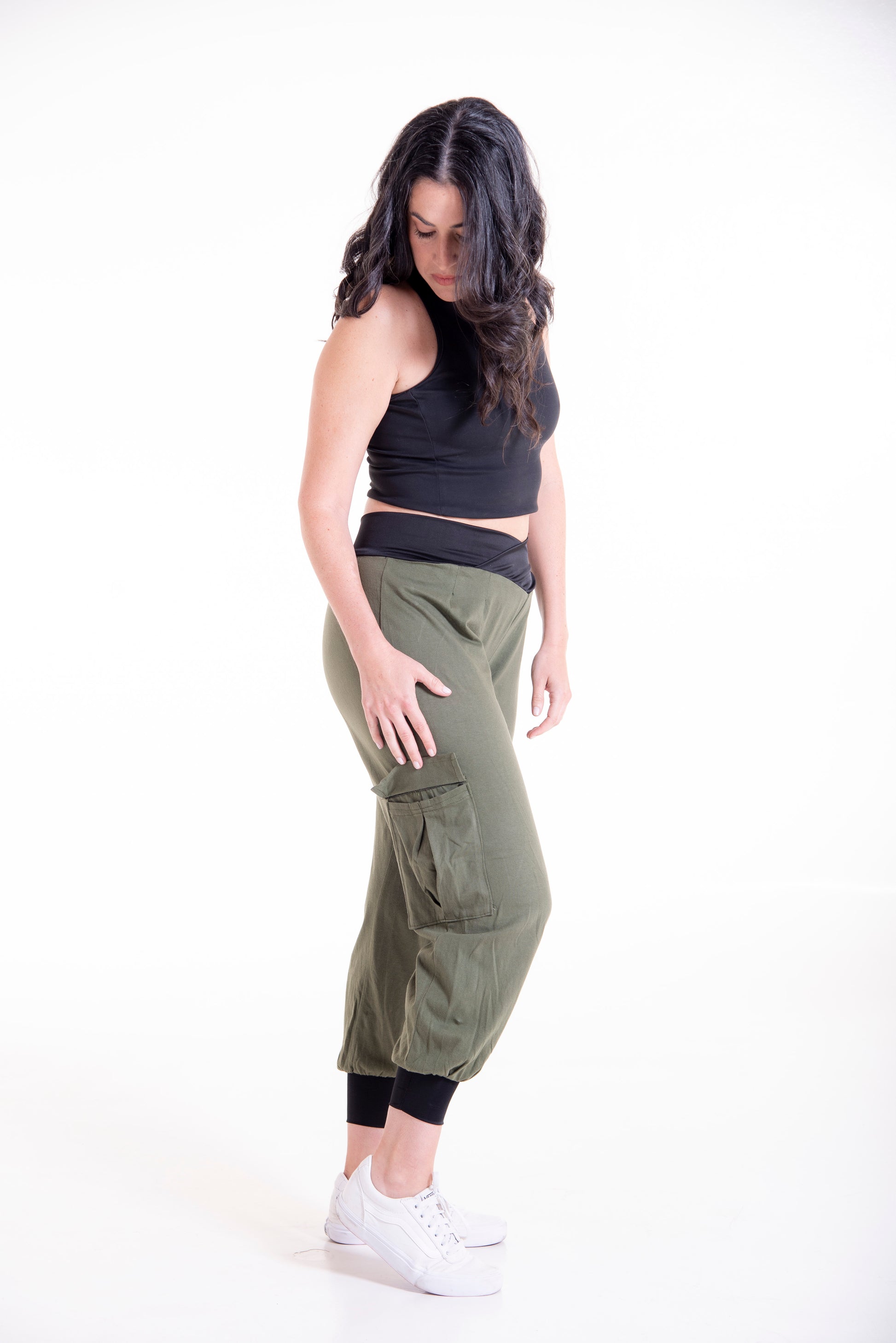 Side view of olive green Flax cargo pants - full length styling