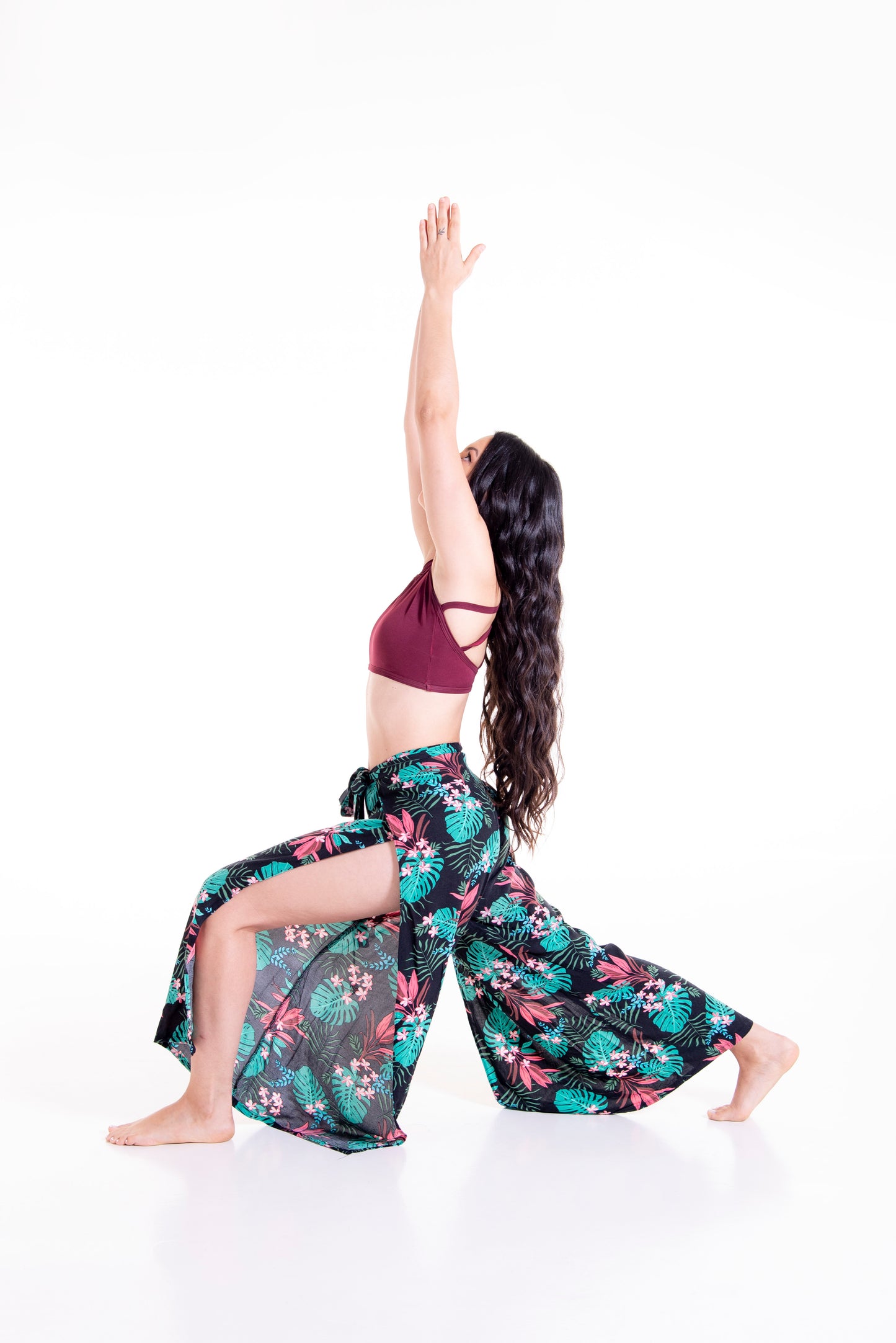 Side view of floral print Ivy wrap pants in yoga pose showing movement and flexibility