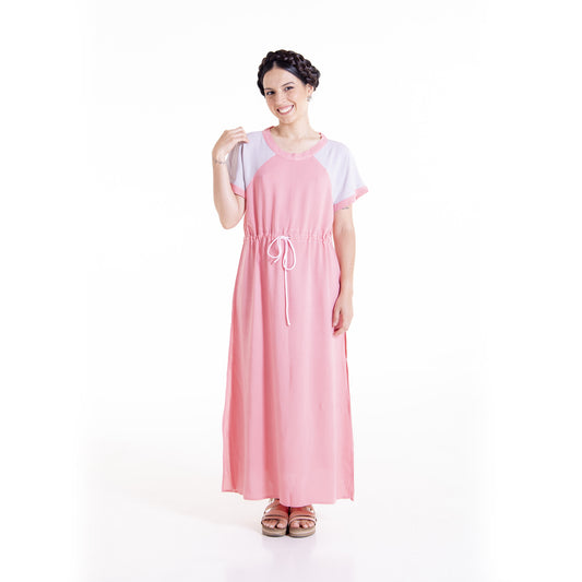 Woman wearing pink Willow raglan maxi dress with pockets - sewing pattern by The Bobbin Bloom